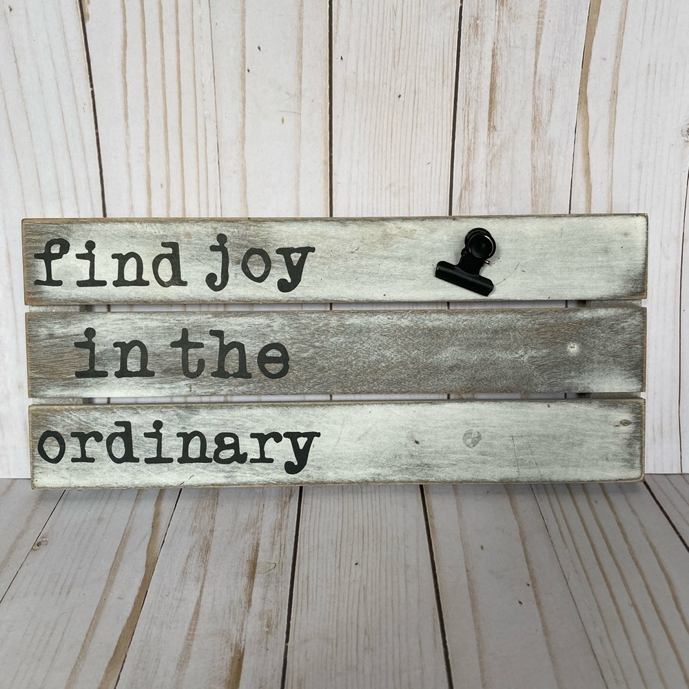 Wooden find joy sign with paper clip